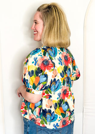 Multicolor floral blouse with smocked detail and short sleeves