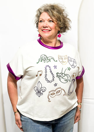 Short sleeve tee with metallic purple contrast on the sleeve and collar. Sequin Mardi Gras symbols on front. 