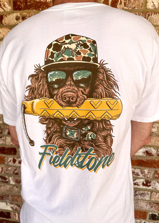 Cream Fieldstone men's tee with duck hunting dog graphic wearing camo hat and sunglasses.