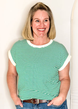 Green and white striped short sleeve top with white banding on sleeve and collar. 