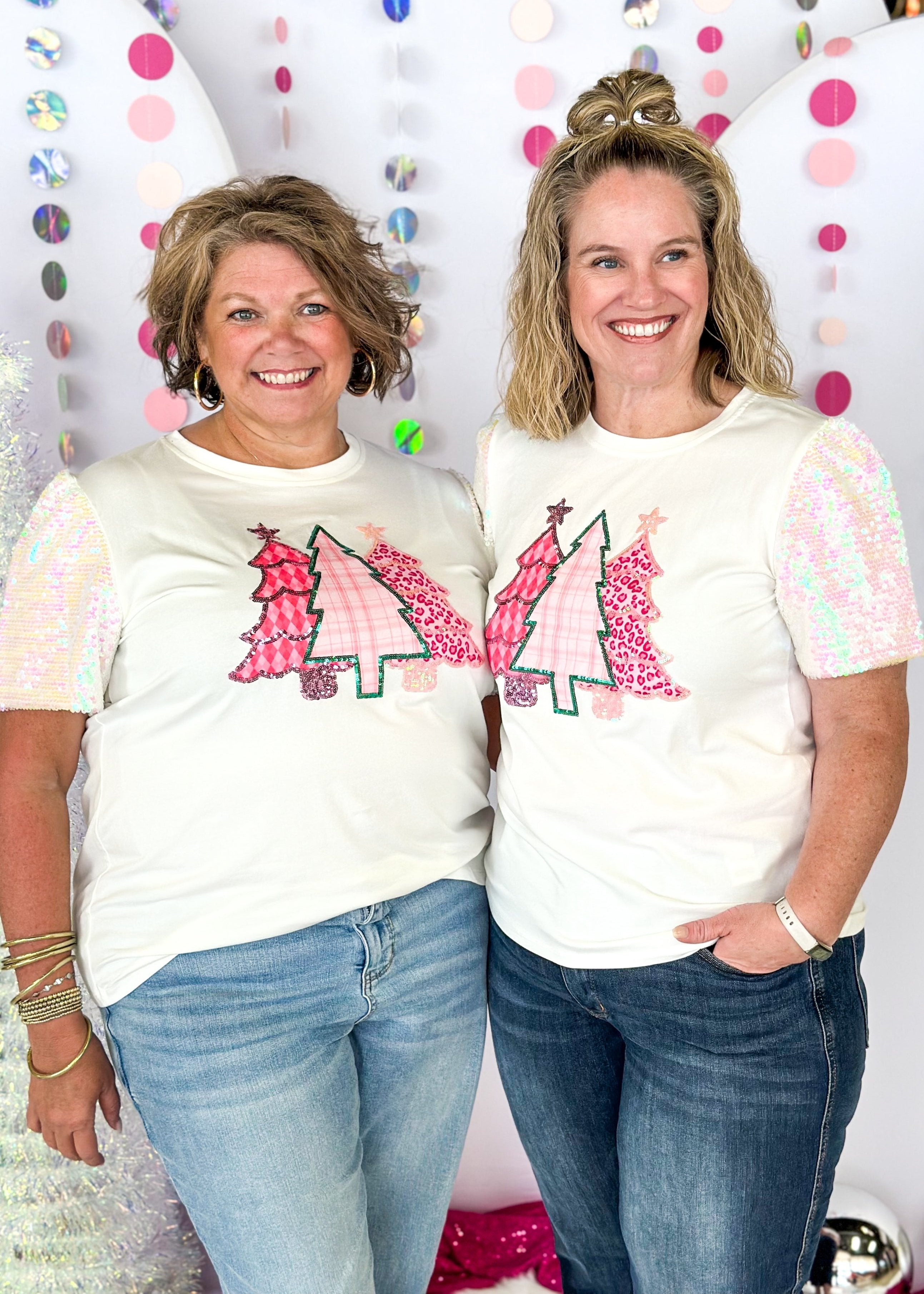 white short sleeve top with iridescent sequin sleeves, round neck, sparkly trio of trees patch on the front