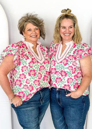 pink floral with large double ruffle short sleeve top - ruffles trimmed in pink and white striped contrast also runs along v neck- ruffle color - green stems