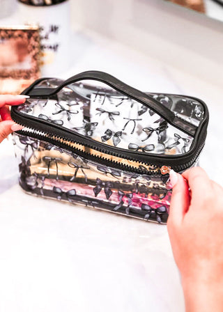 clear cosmetic bag with black bows and trim with zipper
