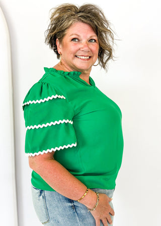 Kelly Green puff sleeve top- 3 tiered white rick-rack Trim on sleeves-
Ruffle Collar, V-neck.  