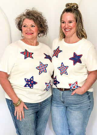 White Ribbed short sleeve top with patriotic star patches, sequin detail.