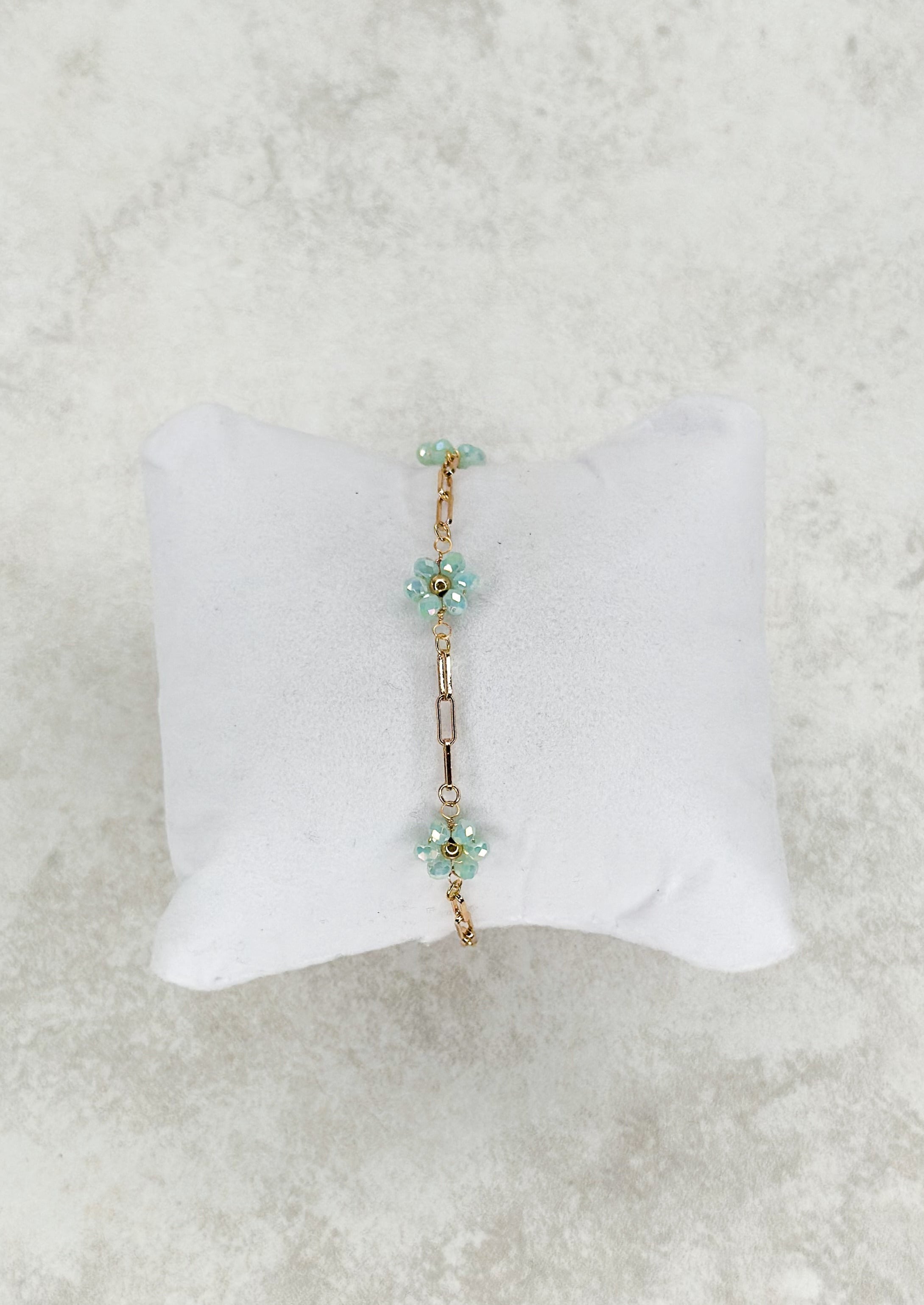 Gold single strand chain bracelet with colored beaded flower. - light blue
