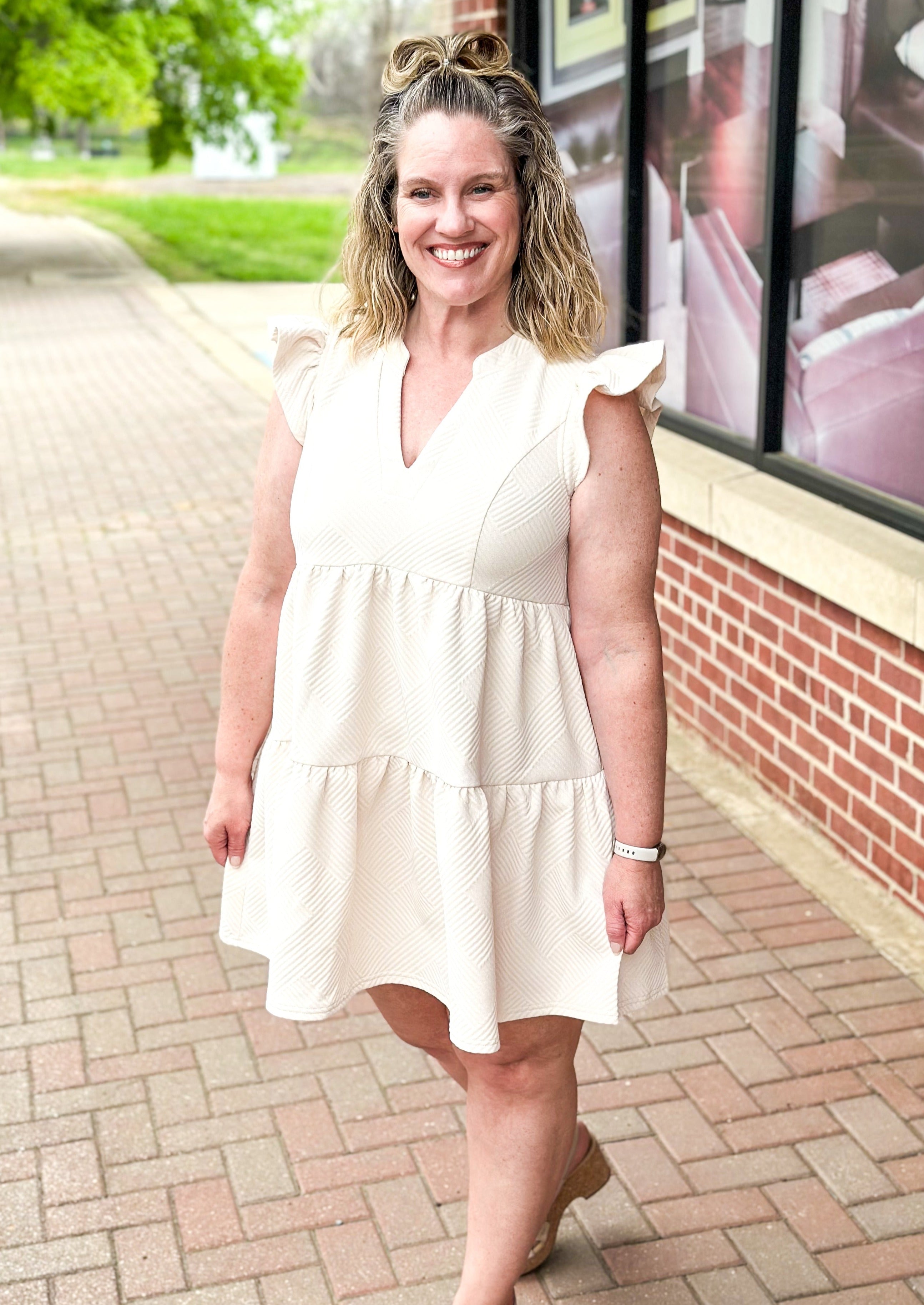 Cream textured tiered dress with ruffle sleeve, pockets, v-neck