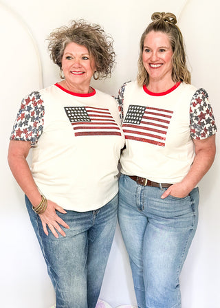 Sequin Flag with red and blue sequin star sleeves and red contrast banding on collar. 