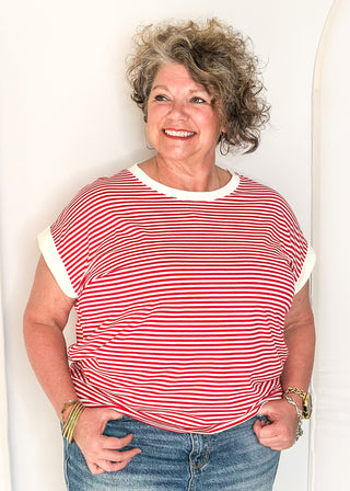 Red and white striped short sleeve top with white banding on sleeve and collar. 