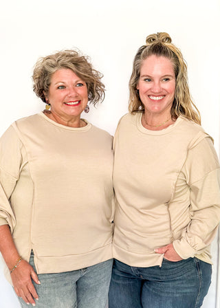 round neck oversized long sleeve with band cut edge detail with slits. 