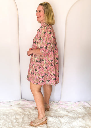 Pink floral short sleeve dress with lined construction, ruffle collar and puff sleeve. 