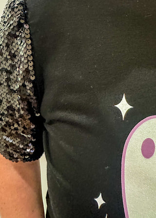 Black short sleeve top with sequin sleeves. Multiple white ghosts on the front