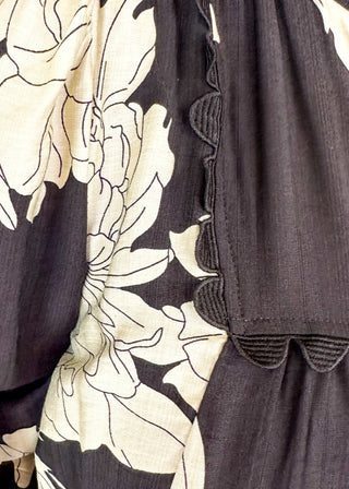 Black knee length dress with large white florals. 3/4 length flowy sleeve. Black scallop detail on chest. Lined 