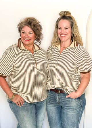 Short sleeve black and off white vertical stripes, zip front collar.  Collar and sleeve has contrast trim with bold stripe