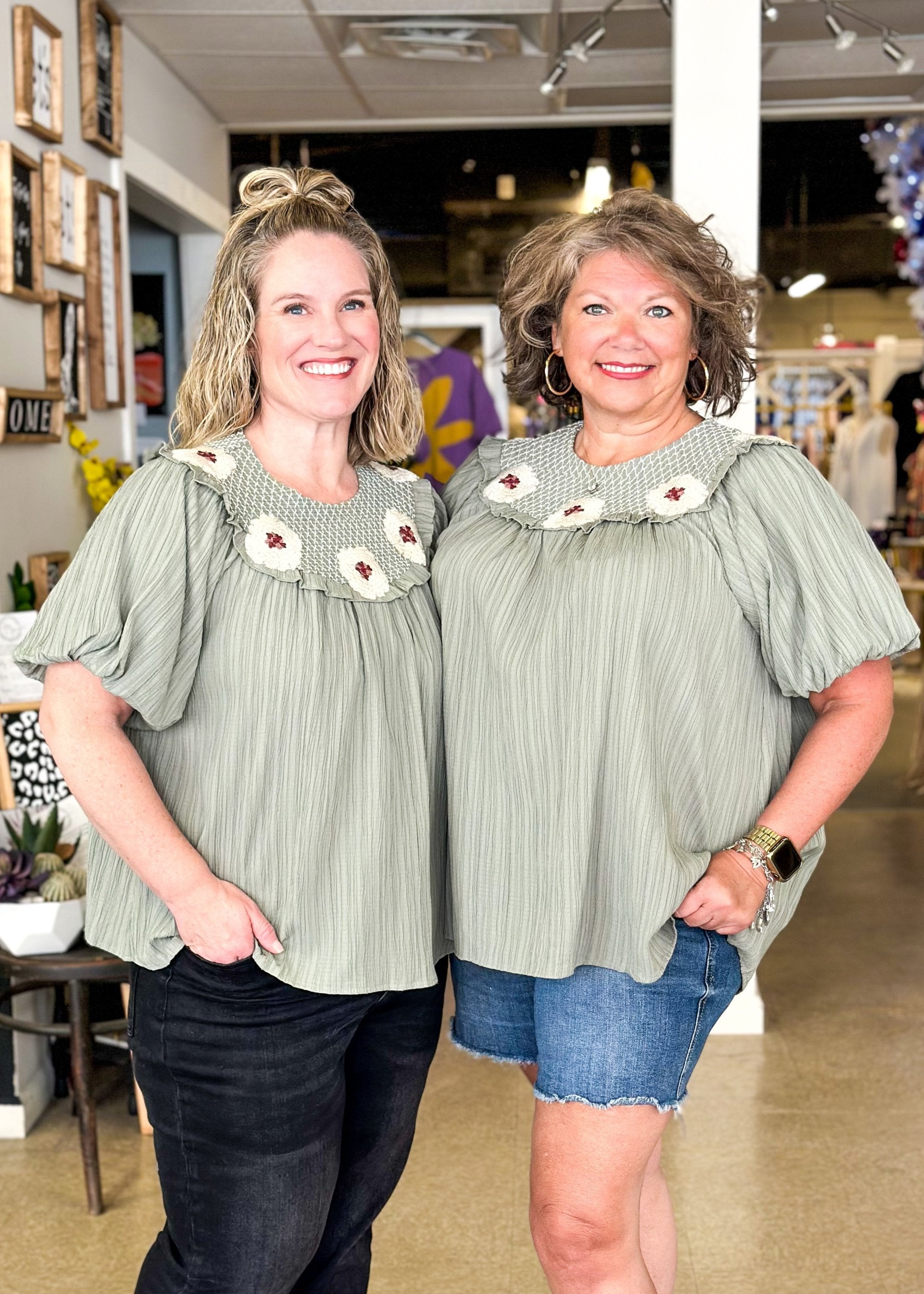 sage green crepe like flowy top with puff sleeve - crochet flowers around the top 