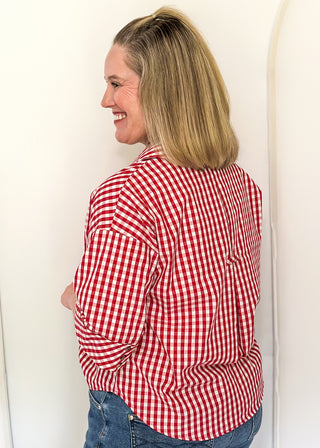 Gingham blouse with split neckline, collar, and 3/4 sleeves.