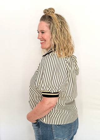 Short sleeve black and off white vertical stripes, zip front collar.  Collar and sleeve has contrast trim with bold stripe