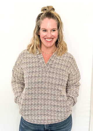 tweed hooded long sleeve top with pockets.  Colors of purple, cream, gray