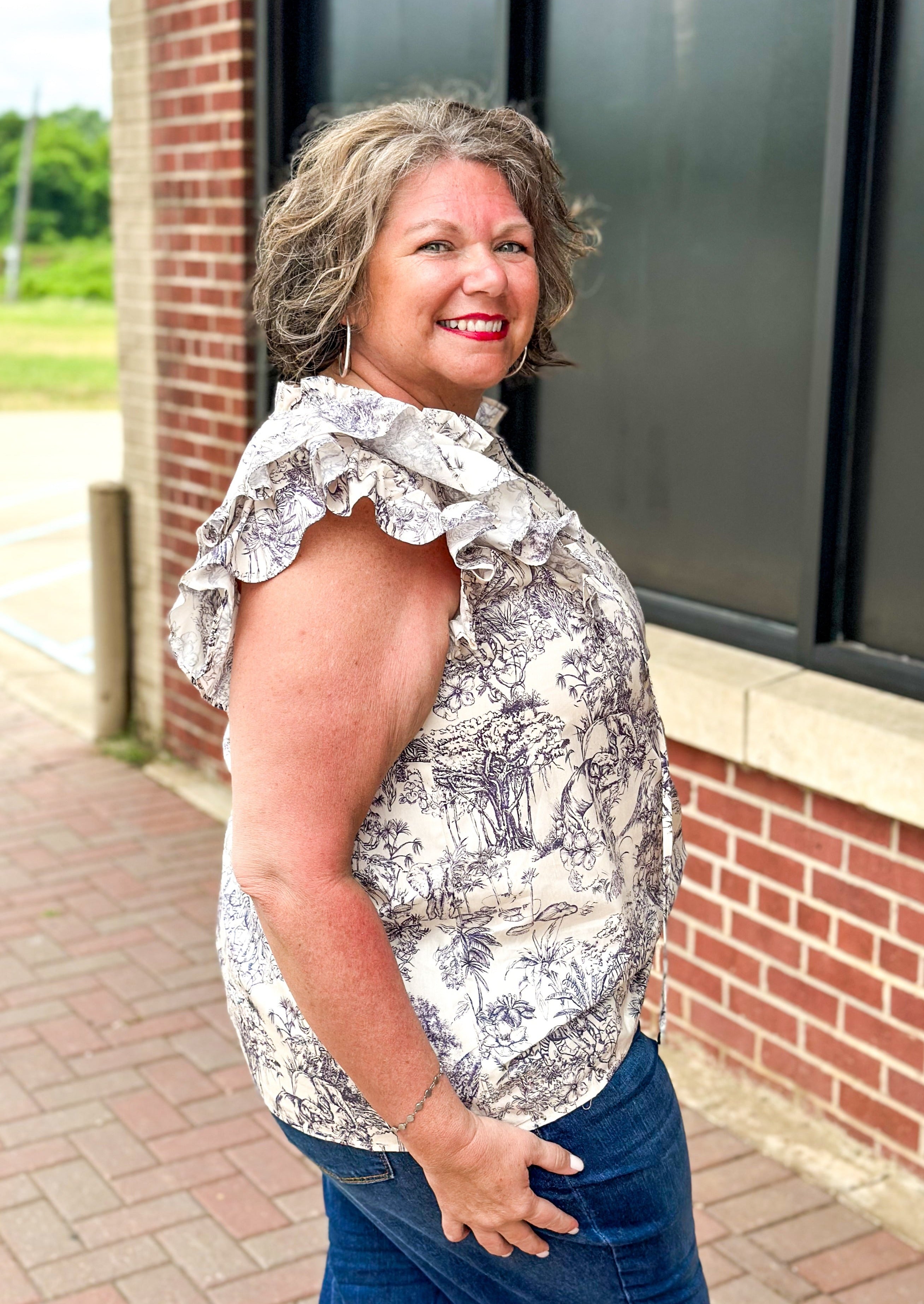 off white double ruffle short sleeve top with ruffle tie v-neck - jungle print scene in a bluish gray