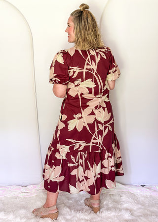 woman wearing tiered midi dress in Burgundy abstract floral print.
