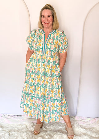 Floral midi dress with contrast neckline, short puff sleeves, and tiered skirt