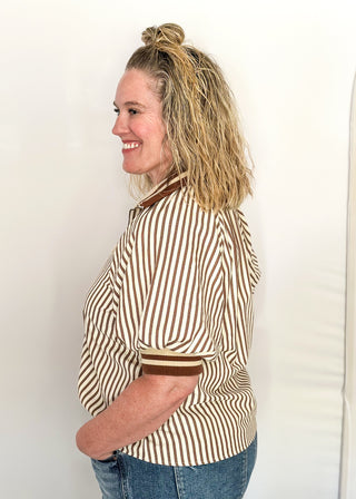 Short sleeve black and off white vertical stripes, zip front collar.  Collar and sleeve has contrast trim with bold stripe