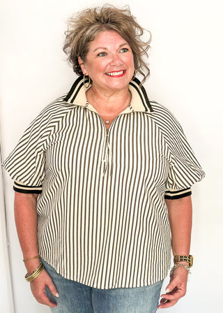 Short sleeve black and off white vertical stripes, zip front collar.  Collar and sleeve has contrast trim with bold stripe