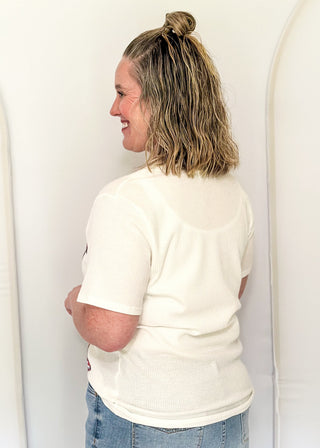 White Ribbed short sleeve top with patriotic star patches, sequin detail.