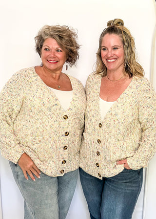 multi fleck of color on this cream button up cardigan.  Oversized fit with two large pockets on the front. 