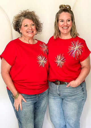 Red short sleeve top with 2 sequin firework bursts.