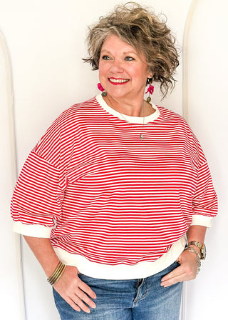 Striped knit dolman top with crew neckline and ribbed trim in red.