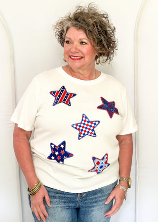 White Ribbed short sleeve top with patriotic star patches, sequin detail.