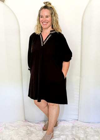 Solid black lightweight dress with v-neck and 3/4 length sleeve. Leopard lace detail on the sleeves, collar and v-neck.