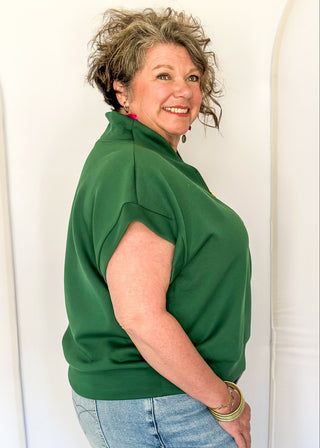 Green scuba fabric athleisure top with zip detail and modern silhouette