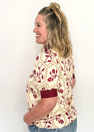 Neutral blouse featuring garnet florals with geometric hexagon pattern.