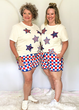 Red, white, and blue checkered shorts with drawstring elastic waist and pockets.