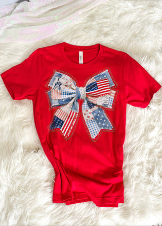 Red short sleeve tee with Americana quilted bow graphic and rhinestone detail.