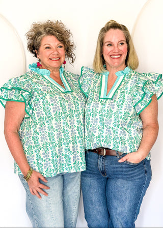 Floral print top with decorative neckline and short ruffle sleeves