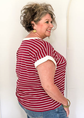 wide striped top with cuffed sleeves, and white banded rounded neckline.