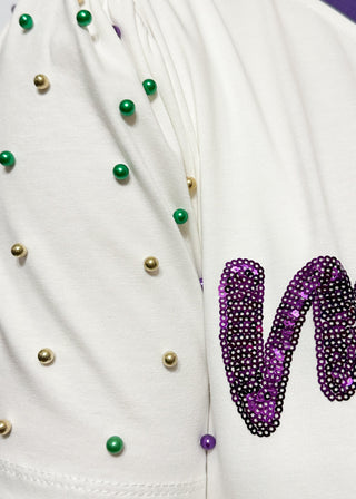 Short sleeve top with pearl accents with sequin "Mardi Gras" wording.