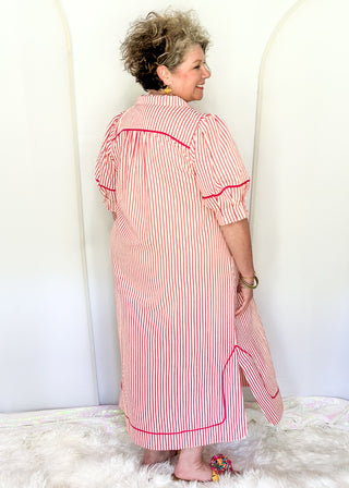 Raspberry and white vertical stripes on a short sleeve v neck midi dress. 