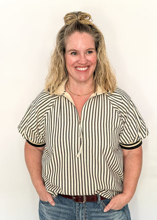 Short sleeve black and off white vertical stripes, zip front collar.  Collar and sleeve has contrast trim with bold stripe