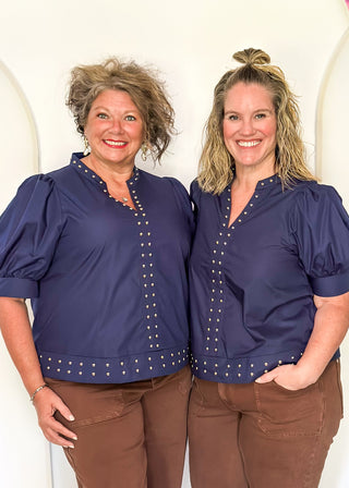 Navy v-neck blouse with puff sleeve.  Silver stud detail along hem, collar and down the front. 