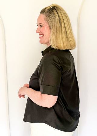 Collared black blouse with detailed gold snaps. short sleeve