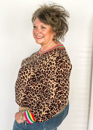 Long sleeve sweater in bold leopard print and colorful stripe collar.