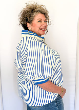 Women’s blue striped short sleeve 1/4 zip top with lightweight fabric, stripe elastic sleeve and collar detail.