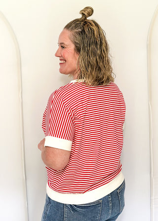 Woman wearing a red and white striped shirt against a white background
