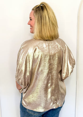Shimmer Champagne V-neck blouse with relaxed elastic short sleeves and a split hem at waist. 