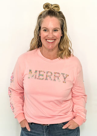 Light pink long sleeve top with beaded ‘MERRY’ lettering across the chest and sequin and beaded snowflakes on the sleeves. 