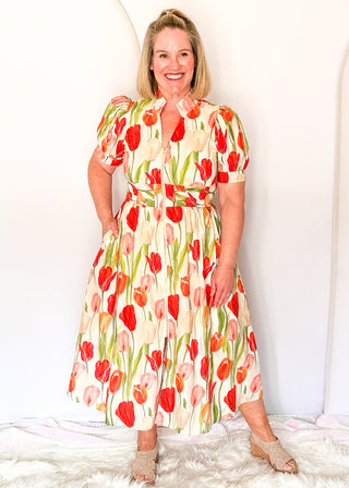 Tulip print midi dress with short sleeves, smocked waist, pockets, and lined fabric
